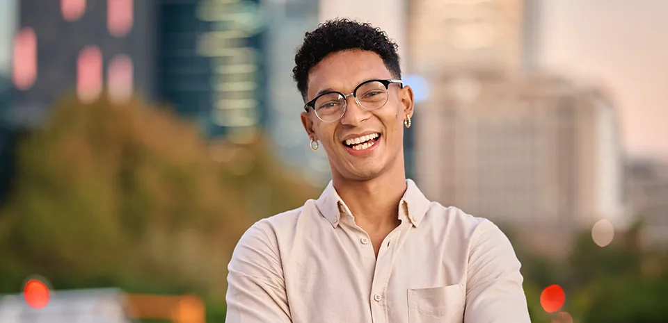 Happy male student intern with short curly dark hair wearing beige dress shirt