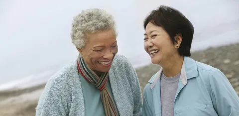 two elder women enjoying time together and laughing 
