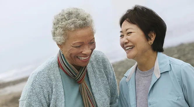 two elder women enjoying time together and laughing 